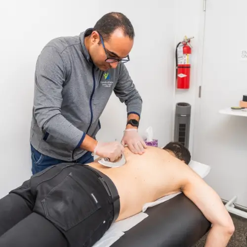 Therapist using metal tool for soft tissue treatment