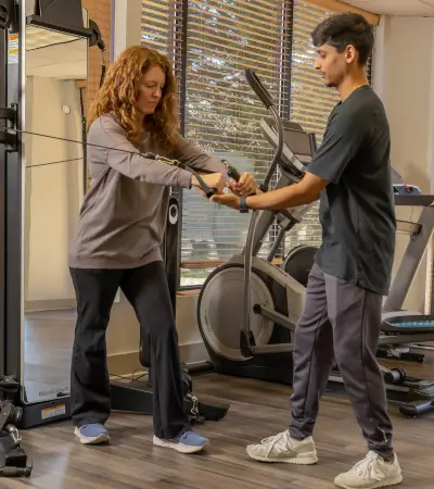 Patient performing strength training with Neufit device