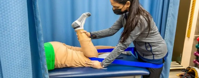 Therapist guiding patient through functional exercise session